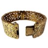 Bracelet manchette en or jaune 750 millièmes (18K) à décor ciselé et ajouré de feuilles stylisées. Fermoir à cliquet (chaînette 