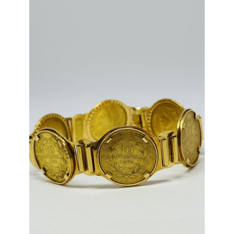 Bracelet articulé en or jaune 750 millièmes (18K) composé de six pièces de 10 francs NAPOLEON III années 1867/64/63 (X2)/62/66. 